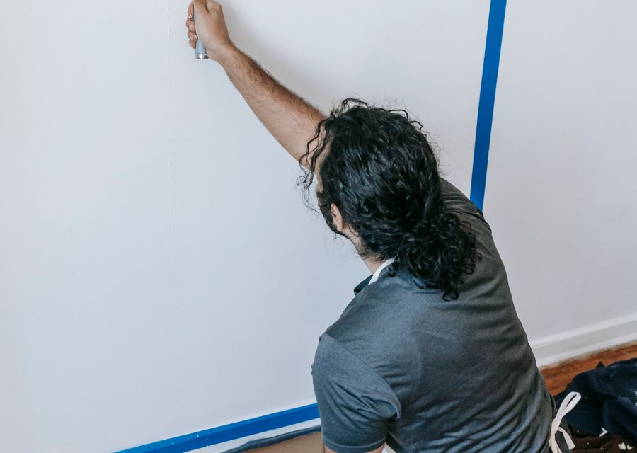 Crisp cut-in line being painted along a masked wall edge