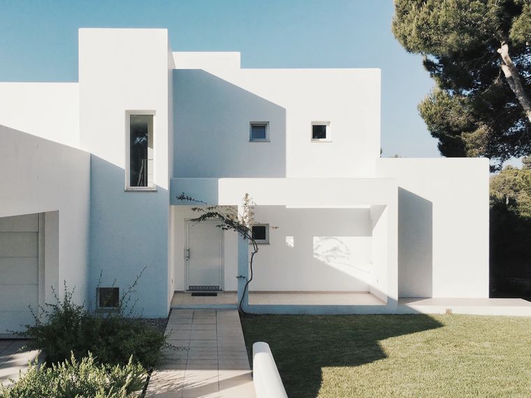 White modern villa exterior in bright sunlight